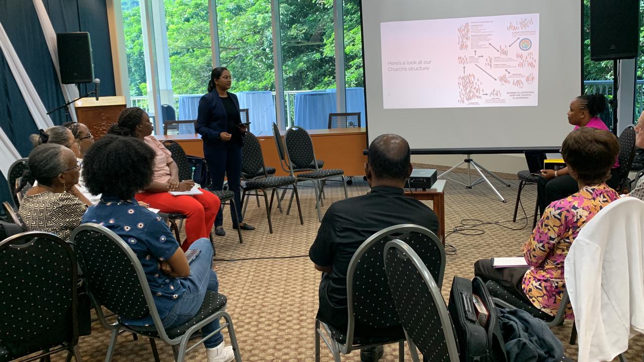 Picture of Dr. Anrisana Jalsa, Souled Servants (SOS) Youth Mission Group of the Presbyterian Church in Trinidad and Tobago presenting to 10 representatives  from different Christian, Jewish and Muslim faiths and civil society organisations