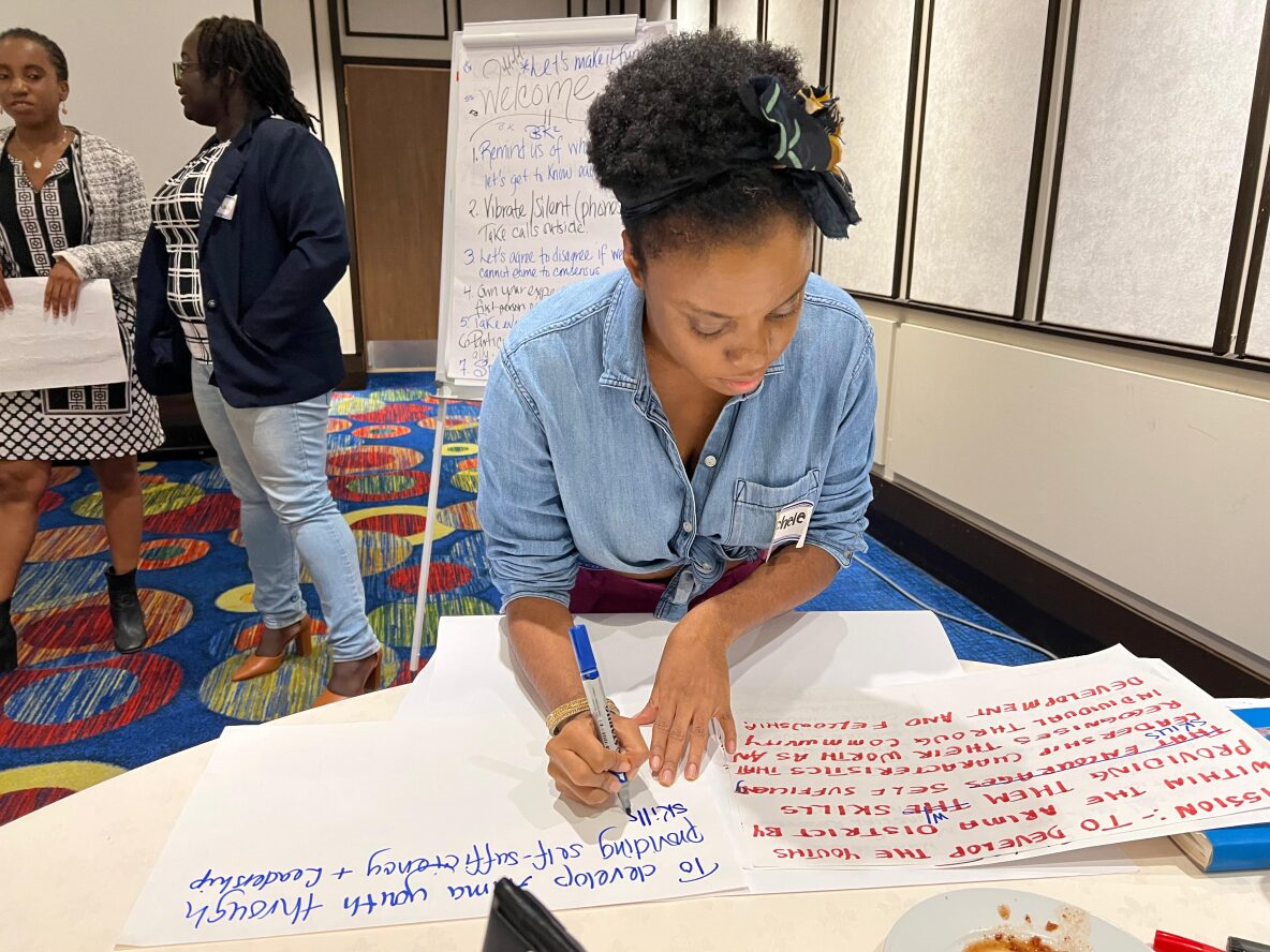 Picture of Facilitator and UN Women Consultant Michele Matthews-Morancie assists a group in streamlining their mission statement for impact and relevance
