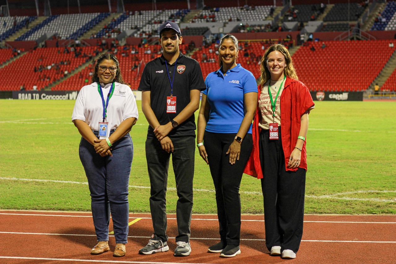Picture of Amiel Mohammed, General Secretary – TTFA joined by UN Women MCO Caribbean staff before the game. L-R Shelly Dolabaille - Communications Analyst, Je’nille Maraj - Planning and Coordination Specialist, and Leah O’Reilly - Programme Associate