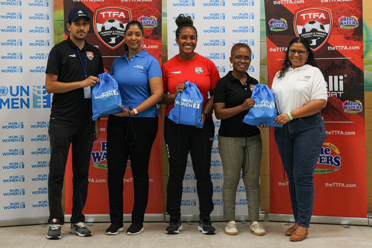 Picture of UN Women MCO Caribbean staff handing over items to TTFA representatives, marking the symbolic start to the partnership, reflecting a shared commitment to advancing gender equality and empowerment through collaborative efforts