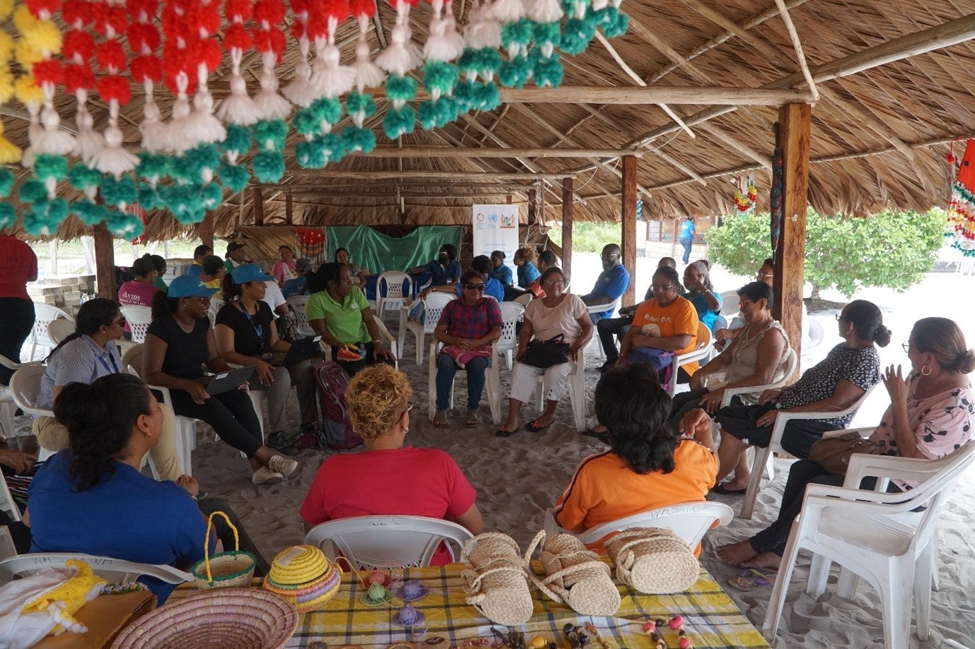 Picture of villagers taking part in the needs assessment focus groups, and openly sharing their experiences with UN Women staff