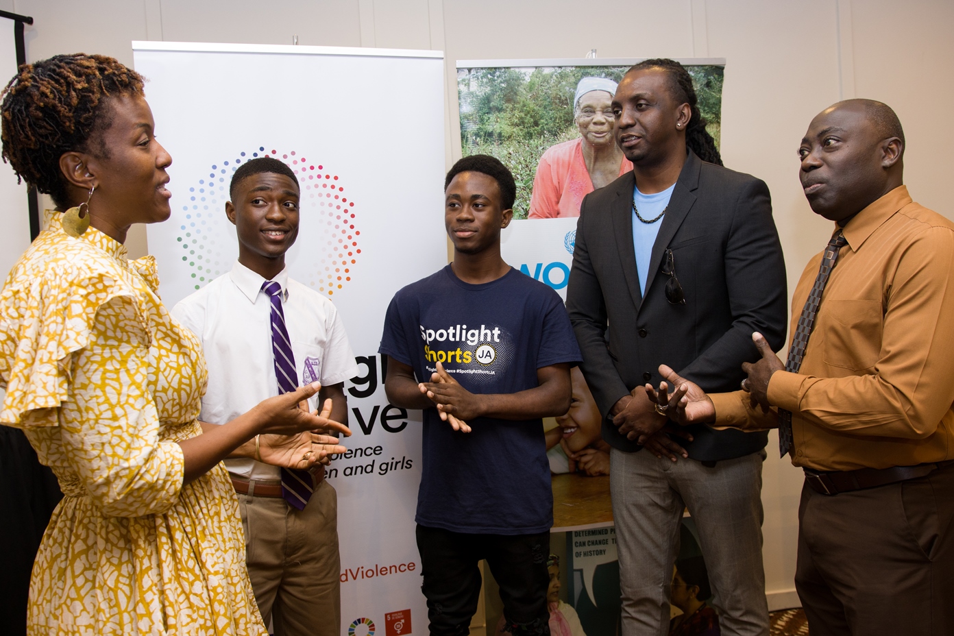 Picture of Tonni Brodber, UN Women Representative speaking to students, Spotlight beneficiary, and Nashan Miller (Bureau of Gender Affairs) and Richard Rowe (YARD)