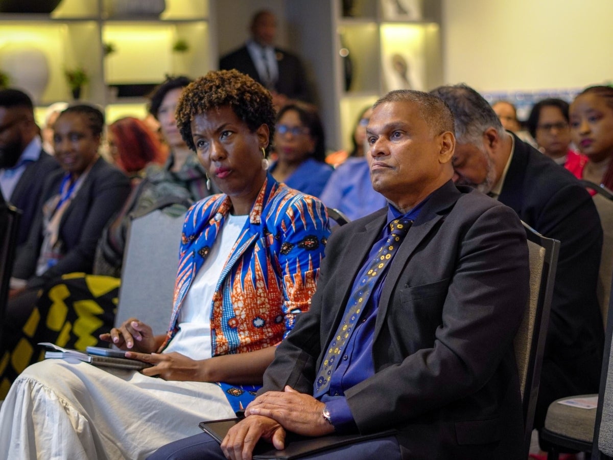 Tonni Brodber, Representative of UN Women MCO - Caribbean, and Vijay Gangapersad, Permanent Secretary of Gender and Child Affairs, listen attentively to one of the presenters