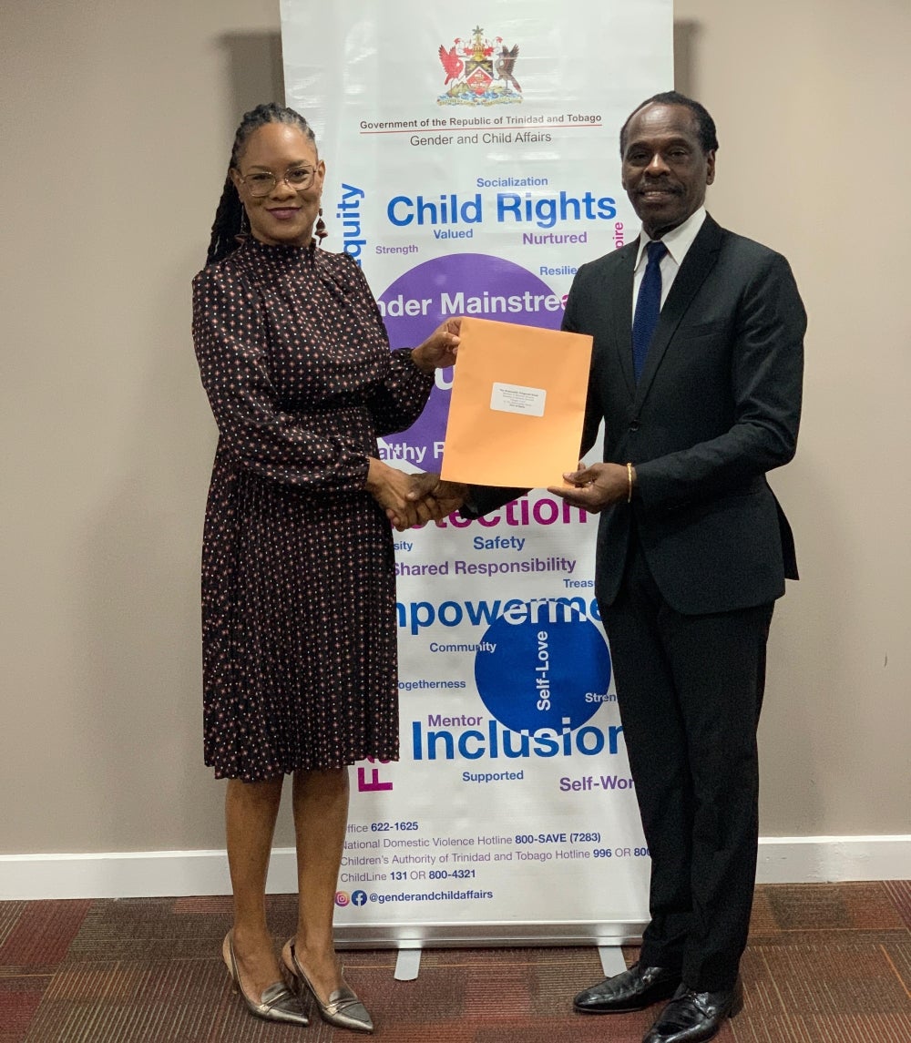 The Honourable Ayanna Webster-Roy, Minister in the Office of the Prime Minister,  presents the official appointment letter to the Honourable Fitzgerald Hinds, Minister of National Security