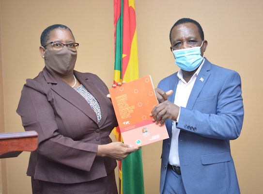 Elaine McQueen handing over report to Prime Minister Dr. Keith Mitchell