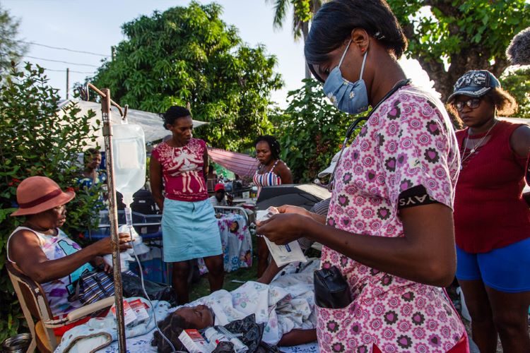 Haitian medical personnel attend to patient