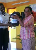UNFPA Assistant Representative De-Jane Gibbons handing over a dignity kit sponsored by UNFPA and UN Women in the wake of Tropical Storm Erika’s impact on Dominica.