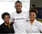 Usain Bolt and Respect Jamaica’s Kemesha Kelly (Left -Programme Manager) and Jordanne Edwards – Youth Engagement Officer