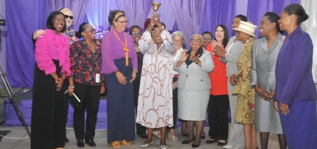 Honourable Minister Olivia Grange rings the bell at the Jamaica Stock Exchange on IWD